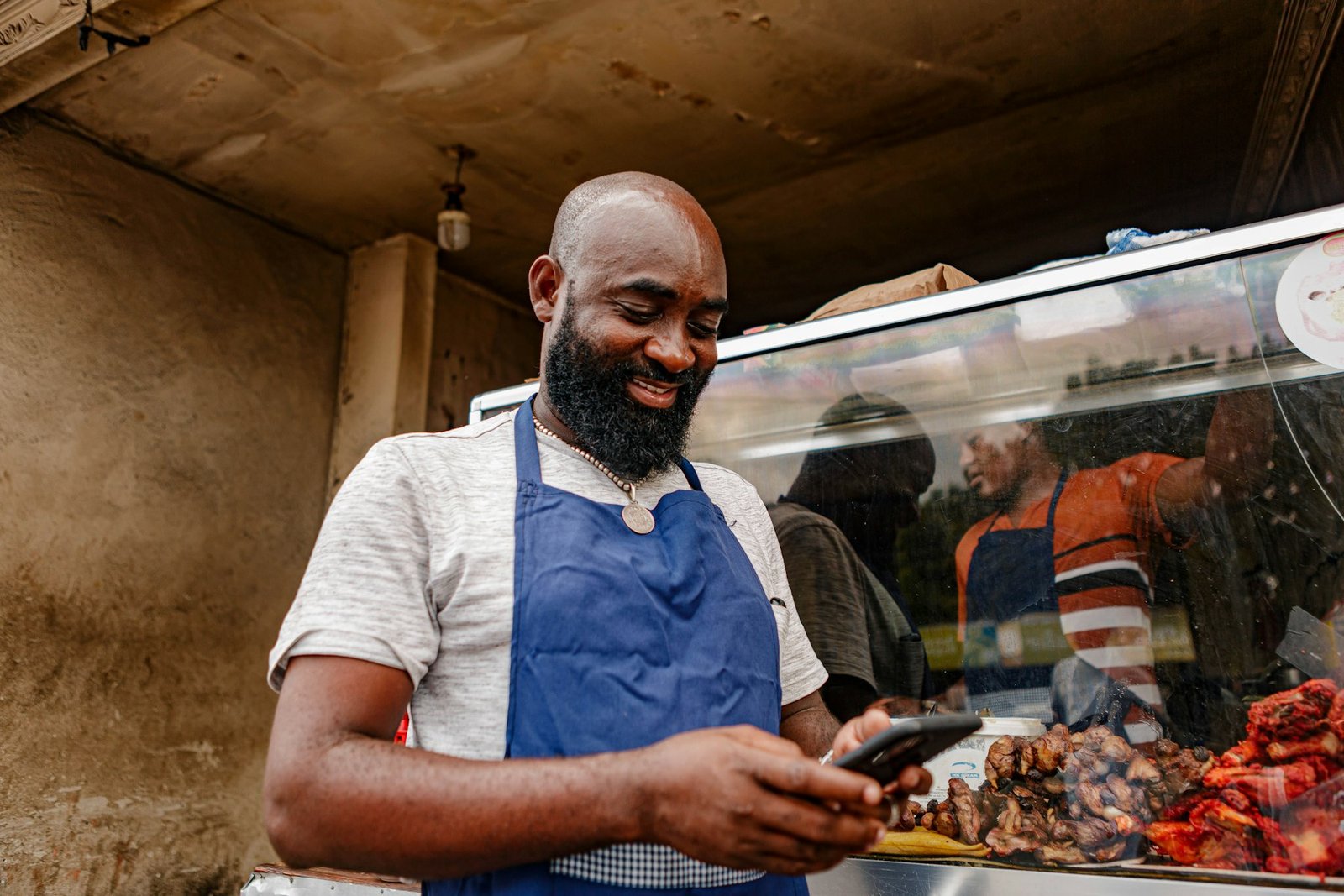 Small business owner checking new customer enquiries on his phone