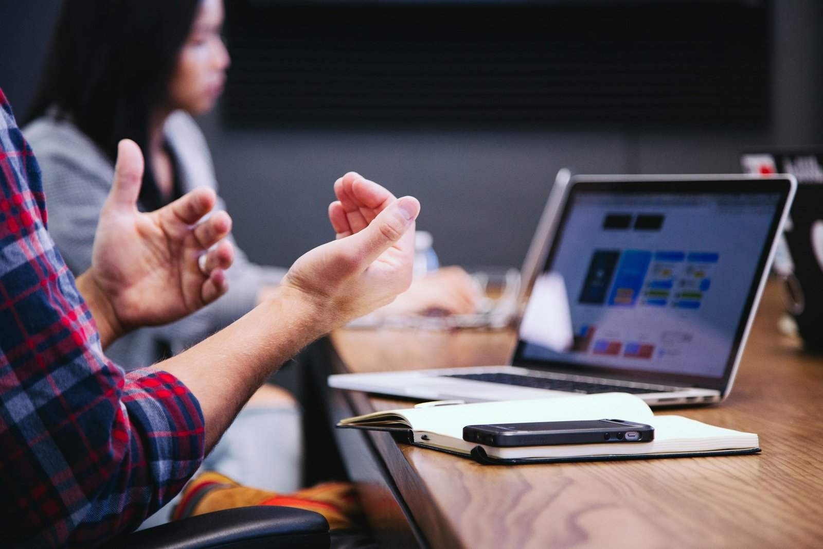 Marketing strategist explaining a search plan during a meeting with a laptop